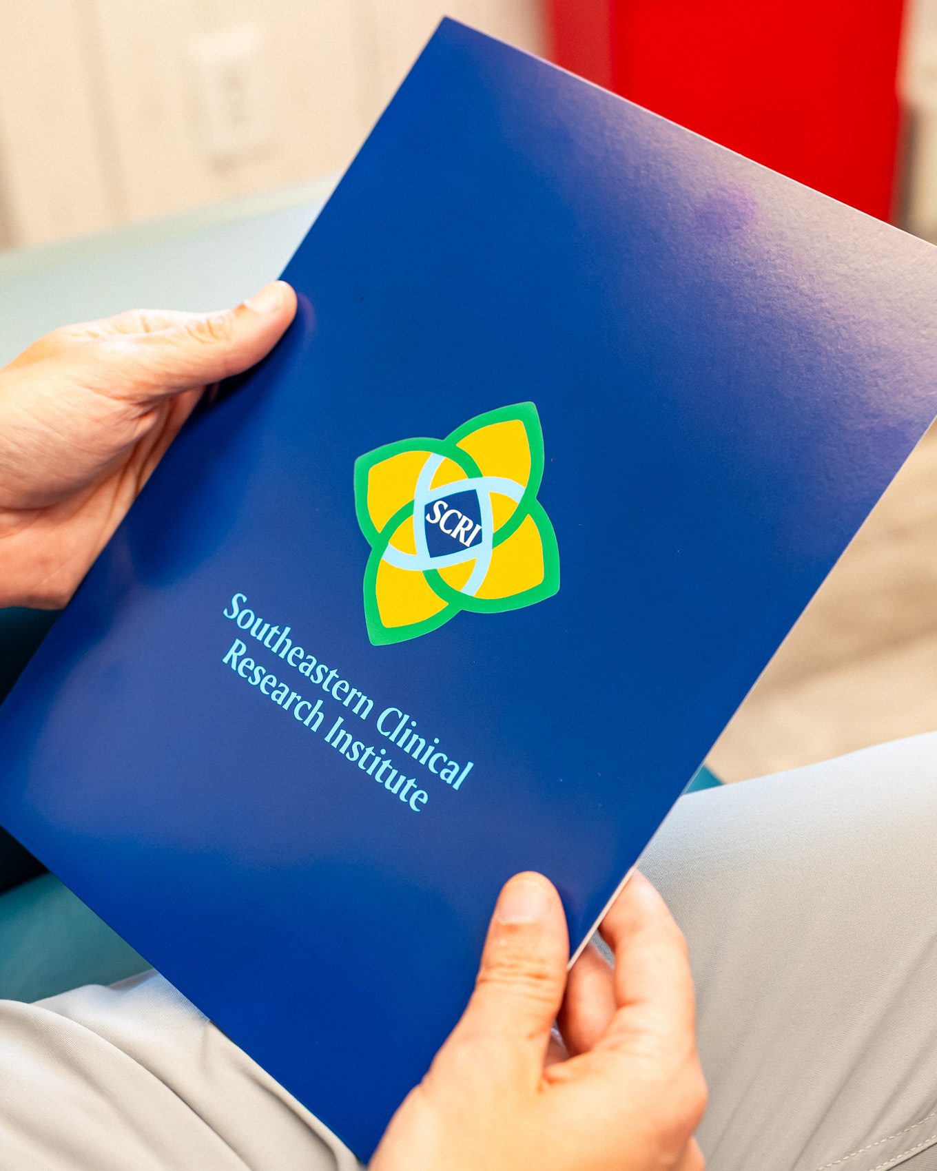 A patient holding an SCRI study folder
