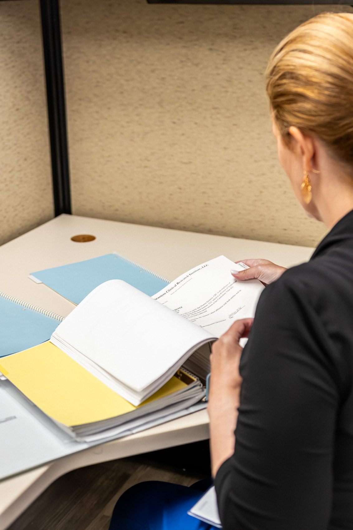 A coordinator reviewing a study binder