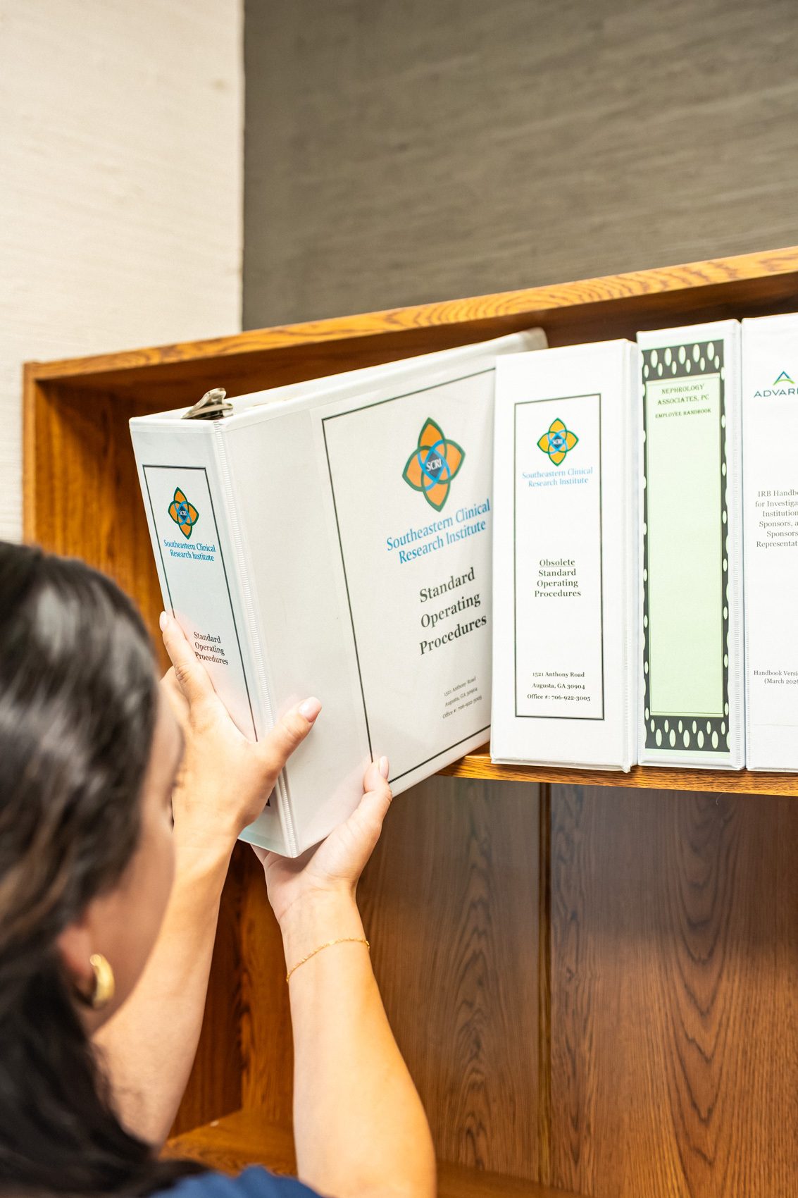 A coordinator pulling regulatory binders at SCRI
